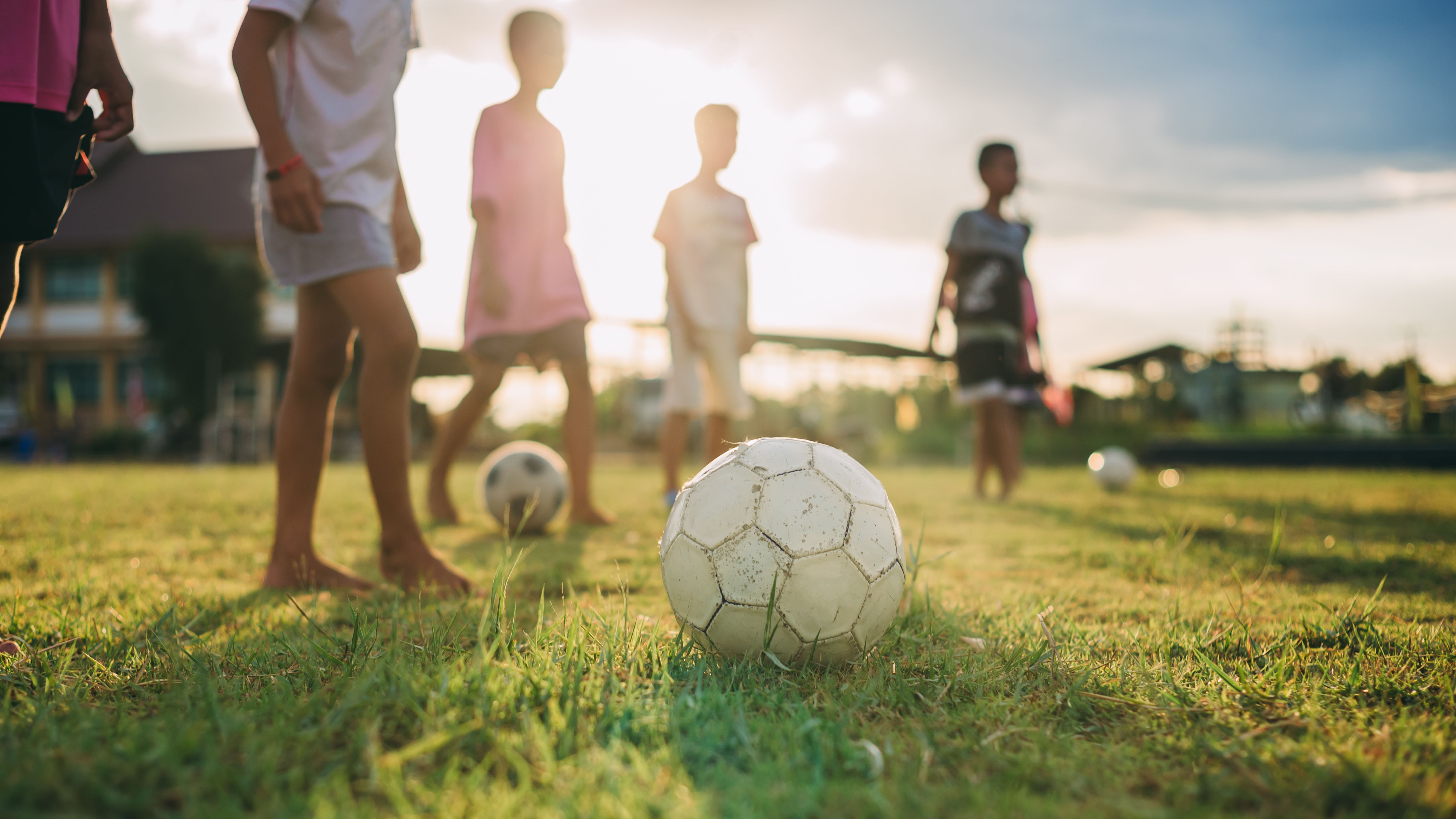 Children playing football in the community