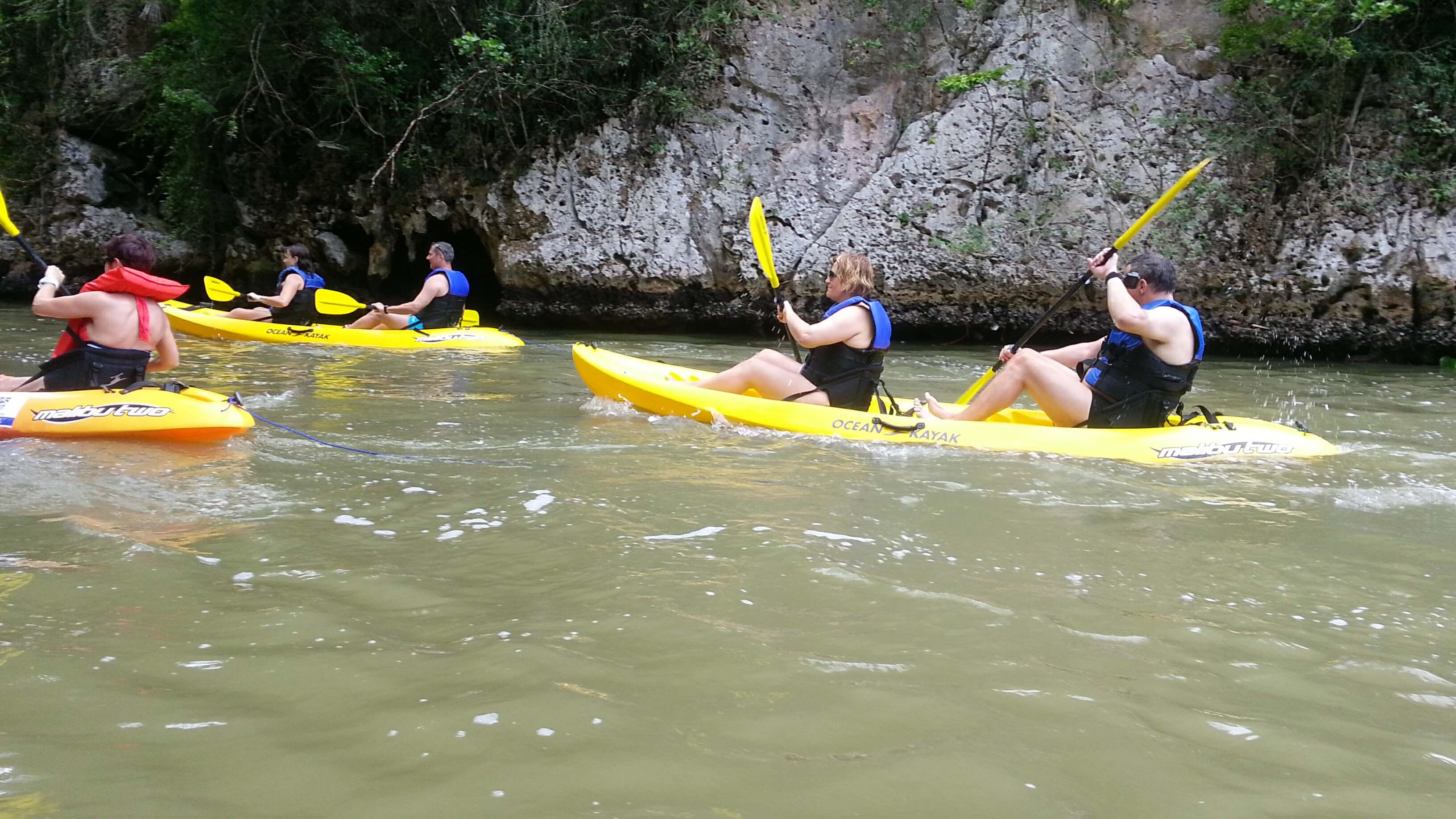 Visitors kayaking beside limestone walls in Los Haitises